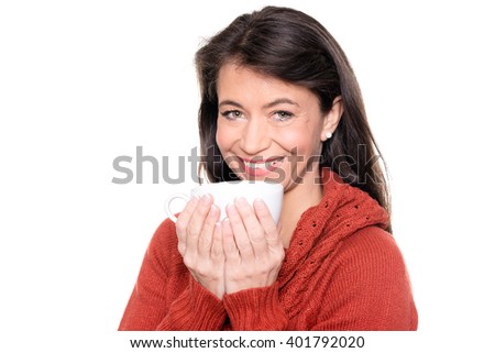 Smiling middle aged woman with a cup in front of white background