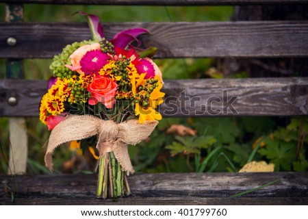 bridal bouquet on bench Royalty-Free Stock Photo #401799760