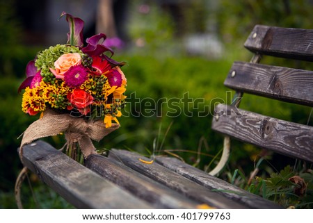 bridal bouquet on bench Royalty-Free Stock Photo #401799763