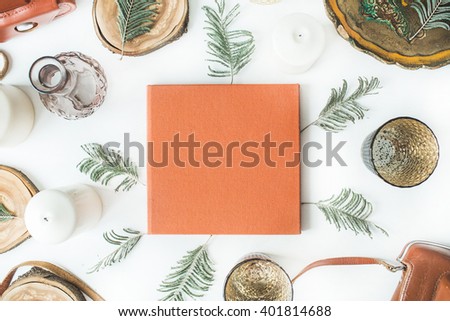 orange wedding or family photo album, vintage old-fashioned camera, candlesticks, candles, branches, old tray and wooden cuts isolated on white background. flat lay, overhead view
