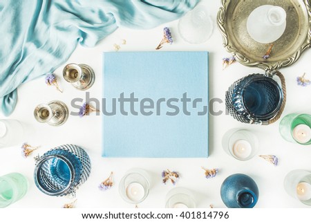 blue wedding or family photo album, vintage old-fashioned golden tray, candlesticks, flowers, silk dress isolated on white background. flat lay, overhead view