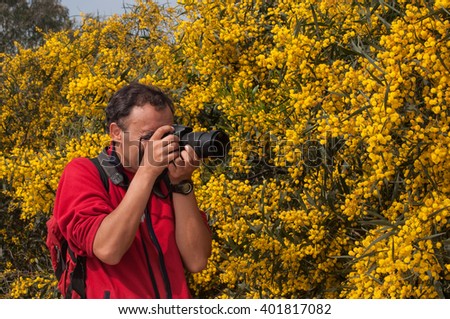 Nature photographer at work in a flowers