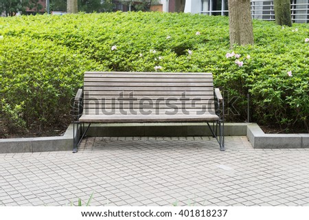 sidewalk scene with wooden bench 