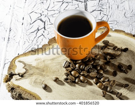 Cup of coffee on a stump. On a light background.
