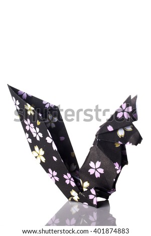 A squirrel origami made of flowery black paper isolated on white background.