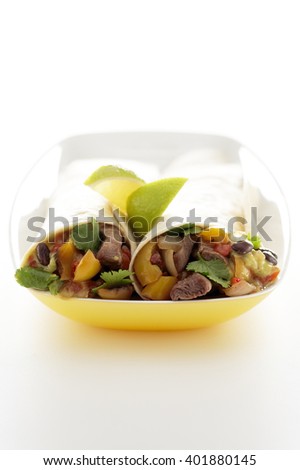 Closeup of fajitas served in plate over white background