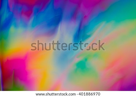 Colorful psychedelic blur showing stress distribution in plastic using polarized light
