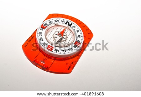 Compass on a white background. Photo of magnetic compass on white paper.