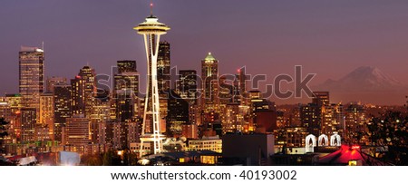 Striking panoramic image of Seattle skyline with Mount Rainier glowing at sunset