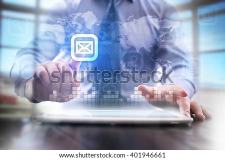 businessman using modern tablet pc and pressing message icon on virtual screen.