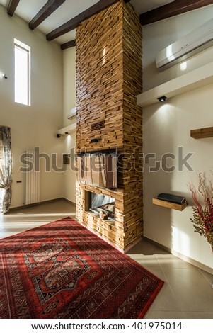 Modern design of fireplace and rustic carpet in luxury home interior