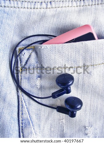 Pink player in jeans pocket with headphones.