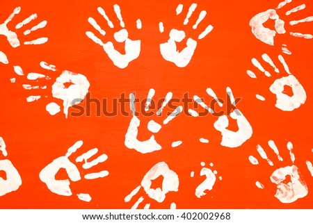 Art prints ，White hands print on orange color wooden sheet background 