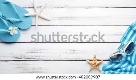 Towel and beach slippers on wood

,summer background.