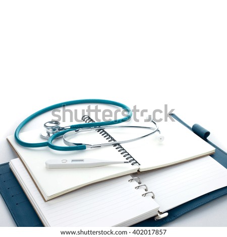 Medical stethoscope and thermometer on a books. Contemporary medicine for healthcare.