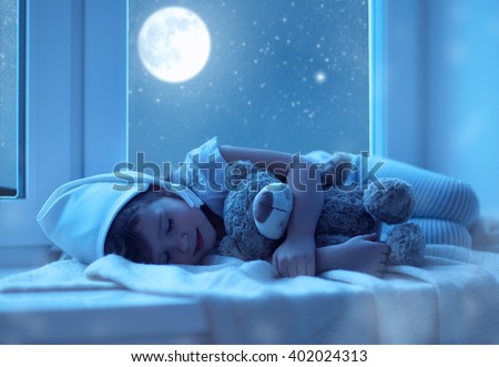 child little girl  sleeping at the window dreaming  the starry sky at bedtime night Royalty-Free Stock Photo #402024313