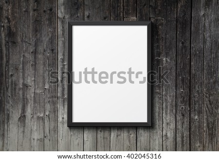 Blank black picture frame on the dark wood texture