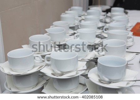 Many rows of coffee or tea cups for background.