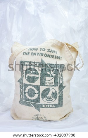 Fabric eco bag with recycle sign on plastic trash.  environmental concept.