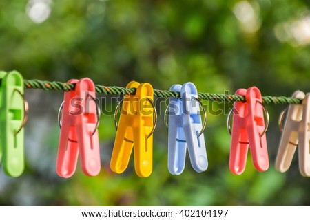 Clothespins and Clothes line on blur background Royalty-Free Stock Photo #402104197