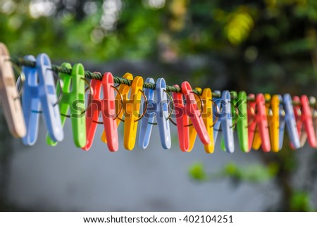 Clothespins and Clothes line on blur background Royalty-Free Stock Photo #402104251