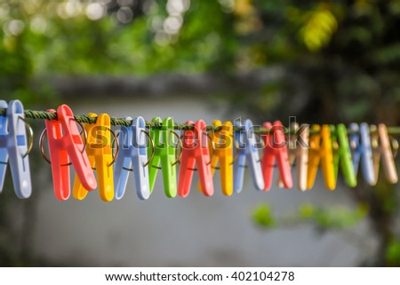 Clothespins and Clothes line on blur background Royalty-Free Stock Photo #402104278