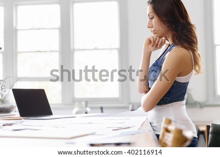 Young woman standing in creative office