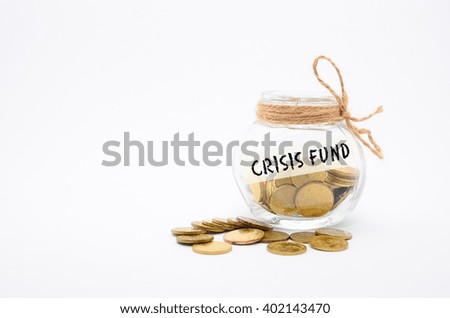 Isolated gold coins in jar with Crisis Fund label - financial concept