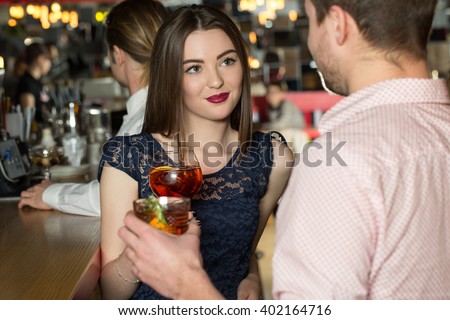 Snorting beauty. Yong female looking straight in the eyes of young man. Royalty-Free Stock Photo #402164716