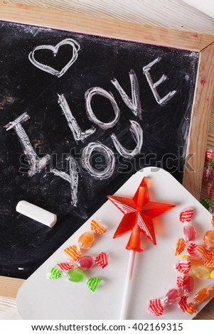 I love you, written on a blackboard with chalk, caramel, candy, star, wand, valentines day, valentine, romantic declaration, sweet tooth, a space for inscription