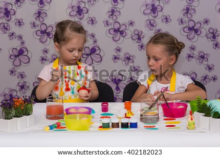 Two girls girlfriends getting ready for the Easter painted eggs
