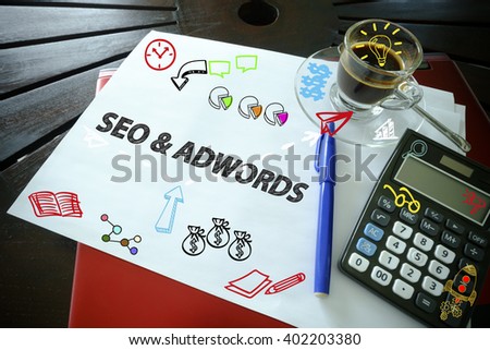 drawing icon cartoon with  SEO AND ADWORDS concept on paper  in the office , business concept