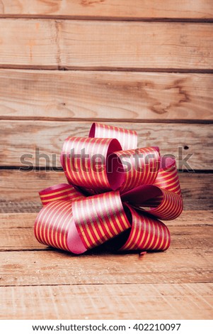 pink bow on a wooden background