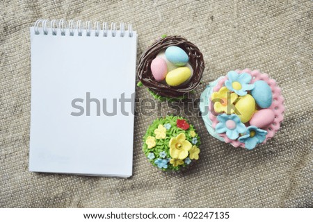 Easter concept, spring has come.Easter background.Easter cooking.Easter cookies.Place for text.Easter cookies and empty recipe book .Beautiful cute Easter cupcakes 