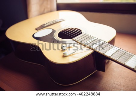 A guitar , close up,Vintage style photo with custom white balance, color filters, soft focus effect, and some fine film grain added