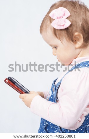Child holding a mobile phone, use the internet or watching cartoons