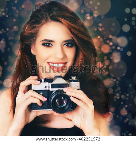 Image of fashion girl make a photo selfie at vintage camera. Take a photography of herself. Funny, party. Beauty. Happy girl smiling. Makeup and hairstyle