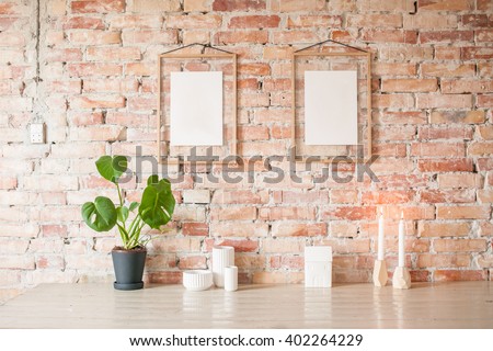 Empty picture in wooden frame where you can write your text, hanging on brick wall