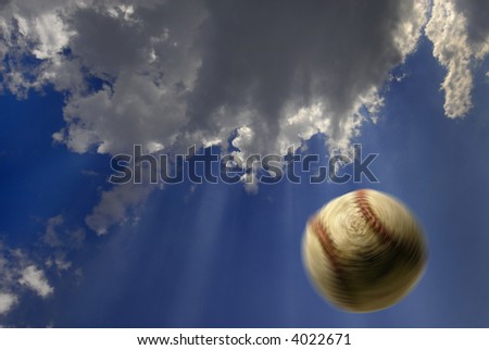 Baseball flying through the air with clouds and sky in background
