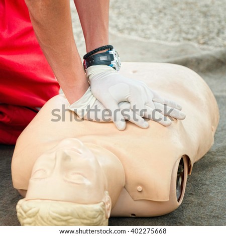 CPR chest compression - demonstration on dummy doll