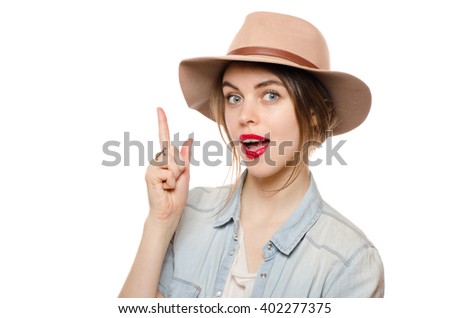 Beautiful young woman in hat  with finger point up have an idea