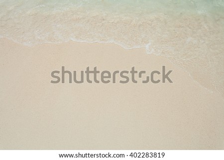 Wave on beach. Detailed sand texture and background.