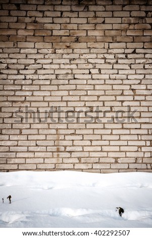 White brick wall and a ground covered with snow