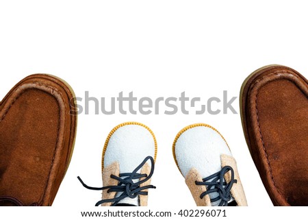 Daddy's boots and baby's shoes, fathers day concept. isolated Royalty-Free Stock Photo #402296071