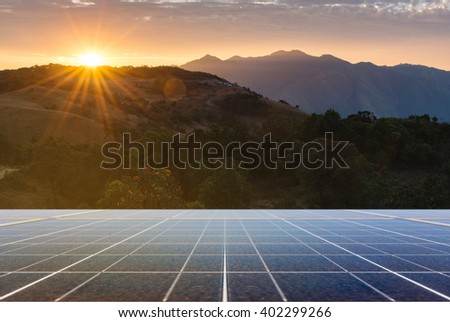Power plant using renewable solar energy with sunset over the Gap in the Great Smoky Mountains background