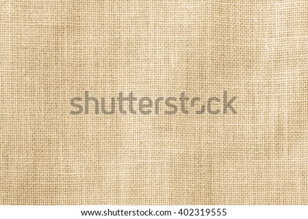 Jute hessian sackcloth woven organic burlap, hemp flax texture pattern background in yellow beige cream brown color Royalty-Free Stock Photo #402319555