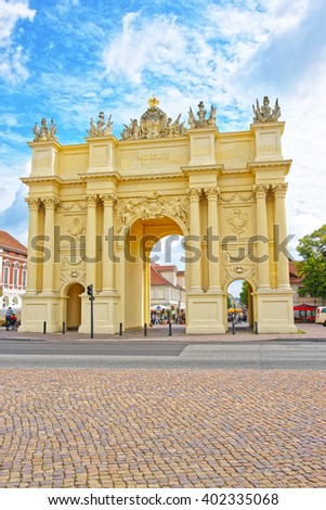 Street view on Brandenburg Gate in Potsdam in Germany. It is placed on Luisenplatz. Tourists nearby