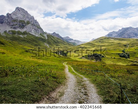 Mountain peaks and unpaved road.