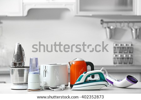 Household and kitchen appliances on the table in kitchen Royalty-Free Stock Photo #402352873