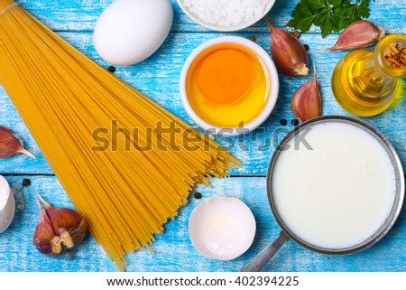 Cooking concept. Pasta with ingredients. Cream, garlic, oil, eggs and herbs.
